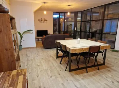 a living room with a table and a couch at Gîte « domaine de l’oustal nau » in Peyriac-de-Mer