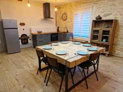 a kitchen with a large wooden table in a room at Gîte « domaine de l’oustal nau » in Peyriac-de-Mer