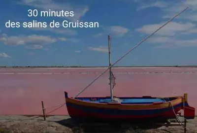 a boat sitting on the shore of a beach at Gîte « domaine de l’oustal nau » in Peyriac-de-Mer