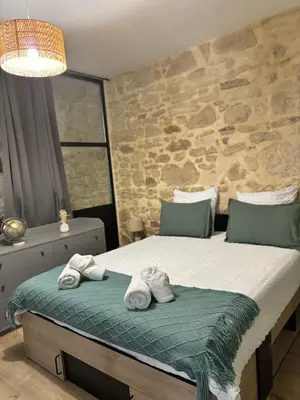a bedroom with a bed with towels on it at Gîte « domaine de l’oustal nau » in Peyriac-de-Mer