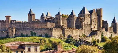 a large castle sitting on top of a hill at La Bastide de Gabin / ConciergerieDameCarcas in Carcassonne