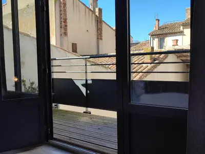 a view of a balcony from an open door at La Bastide de Gabin / ConciergerieDameCarcas in Carcassonne