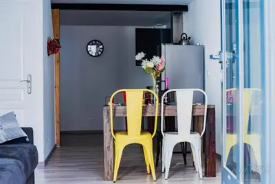 a dining room with a table and two chairs at Le Gabin Moderne Loft in Carcassonne