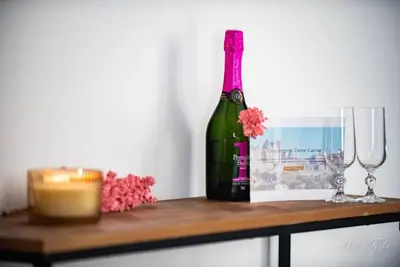 a bottle of wine sitting on a table with two glasses at Le Gabin Moderne Loft in Carcassonne