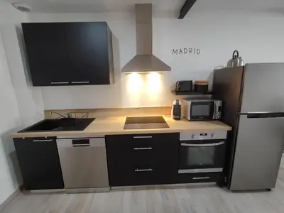 a kitchen with a sink and a refrigerator at Le Gabin Moderne Loft in Carcassonne