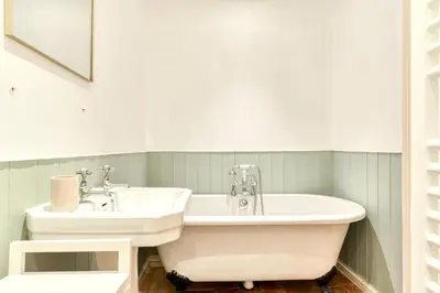 a bathroom with a tub and a sink at Au Puits de la Cité - Terrasse Vue Cité - Wifi in Carcassonne