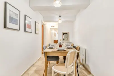 a dining room with a table and chairs at Au Puits de la Cité - Terrasse Vue Cité - Wifi in Carcassonne
