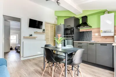 a kitchen with a table and chairs in a room at Côté Palais 2 avec Netflix - Fibre - Proche Cité in Carcassonne