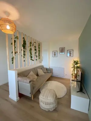 a living room with a couch and a staircase at Appartement cosy, vue imprenable in Carcassonne