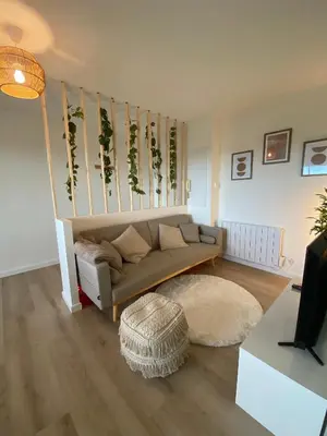 a living room with a couch and a rug at Appartement cosy, vue imprenable in Carcassonne