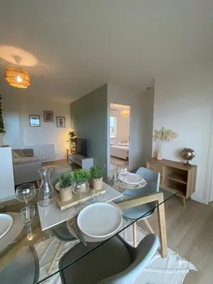 a living room with a table and chairs and a couch at Appartement cosy, vue imprenable in Carcassonne