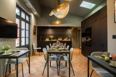 a kitchen and dining room with a table and chairs at La Maison de Jean by Maison Bacou in Carcassonne