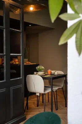a table and chairs in a room with a table at La Maison de Jean by Maison Bacou in Carcassonne