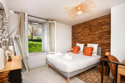 a bedroom with a bed and a brick wall at Le Cocon de la Cité - Parking au Pied de La Cité in Carcassonne