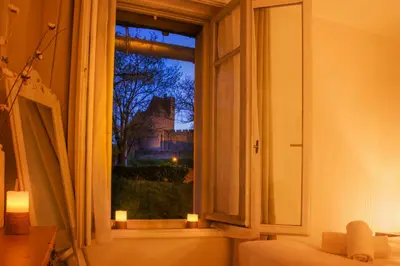 a window with a view of a castle at Le Cocon de la Cité - Parking au Pied de La Cité in Carcassonne