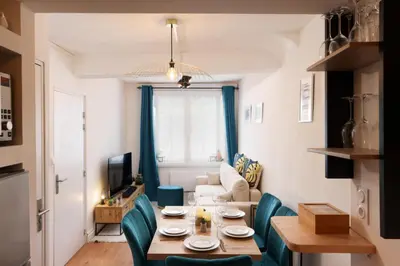 a small living room with a table and chairs at Le Pied à Terre de la Cité - Parking au Pied de la Cité in Carcassonne