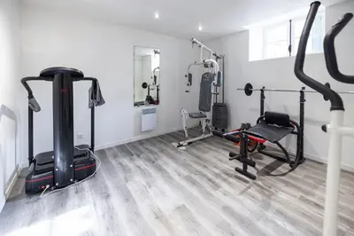 a gym with treadmills and exercise bikes in a room at Pamiers gare - 2 Appartements à louer ou Chambre parentale indépendante in Pamiers