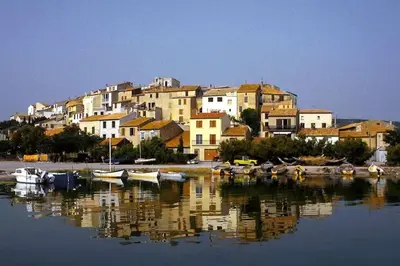 a group of boats in a body of water with houses at La maison d' Anne , nature et convivialité ... in Albas