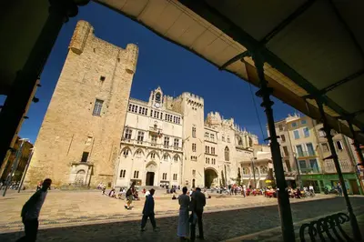 a group of people standing in front of a large building at La maison d' Anne , nature et convivialité ... in Albas