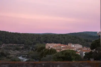 a town in the middle of a valley at sunset at Le Relais de Tamaroque in Portel-des-Corbières