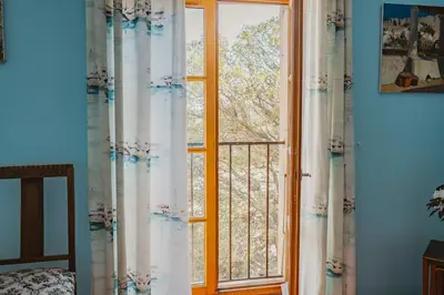 a window in a room with curtains at Le Relais de Tamaroque in Portel-des-Corbières