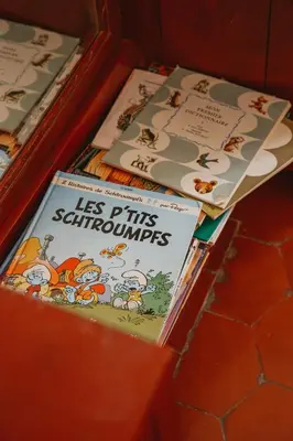 two childrens books sitting on top of a table at Le Relais de Tamaroque in Portel-des-Corbières
