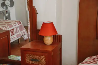 a red lamp sitting on top of a wooden table at Le Relais de Tamaroque in Portel-des-Corbières