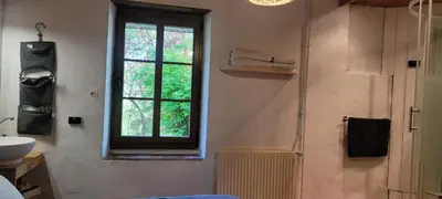a bathroom with a window and a shower and a sink at LA CHAMBRE DU CANTOU in Lautrec