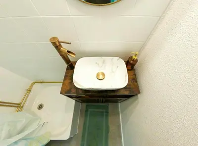 a bathroom with a sink on a wooden table at Splendide appartement GOLDEN HOUSE vue LAC et montagne in Port-la-Nouvelle
