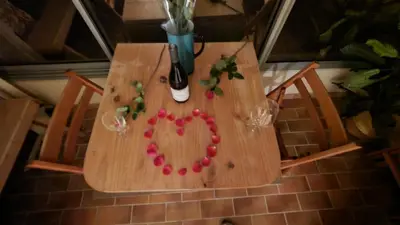 a wooden table with a heart decoration on it at Splendide appartement GOLDEN HOUSE vue LAC et montagne in Port-la-Nouvelle