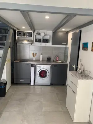 a kitchen with a washing machine and a sink at L appart d Ange 2 idealement situe 47m2 entre le port et le village in Gruissan