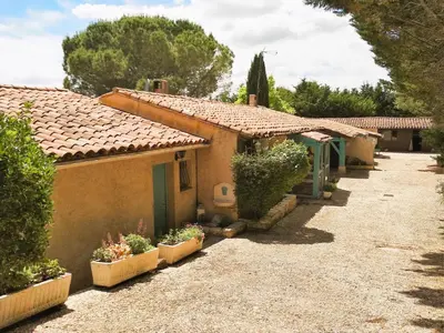 a row of cottages with plants in front of them at Chambre Indépendante Piscine, Parc, Cuisine... in Brézilhac