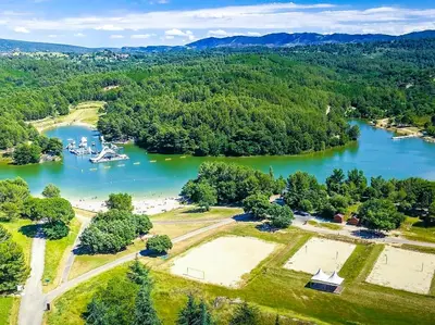 an aerial view of a lake with trees and water at Chambre Indépendante Piscine, Parc, Cuisine... in Brézilhac