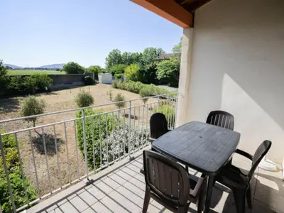 a table and chairs on a balcony with a view at Apartment in Azille near Lac de Jouarres in Azille