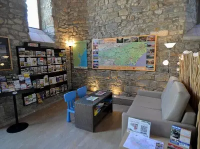a room with a couch and a map on a stone wall at Apartment in Azille near Lac de Jouarres in Azille