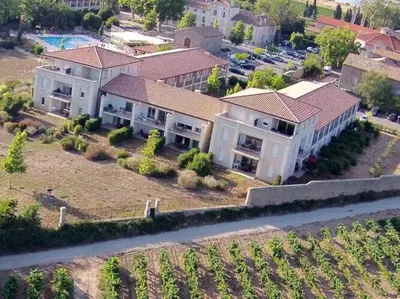 an aerial view of a large house with a parking lot at Apartment in Azille near Lac de Jouarres in Azille
