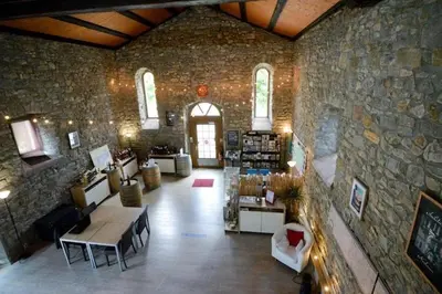 a large room with a stone wall with a table at Residence du Château de Jouarres, Azille - Studio 2 pers with balcony in Azille