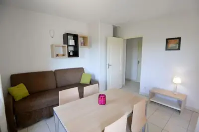 a living room with a couch and a table at Residence du Château de Jouarres, Azille - Studio 2 pers with balcony in Azille