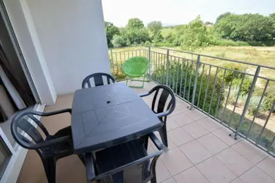 a black table and chairs on a balcony at Residence du Château de Jouarres, Azille - Studio 2 pers with balcony in Azille