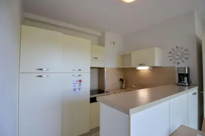 a kitchen with a white refrigerator and a counter at Residence du Château de Jouarres, Azille - Studio 2 pers with balcony in Azille