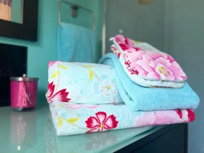 a pile of towels sitting on a counter in a bathroom at Gîte Les logis du Pech in Narbonne