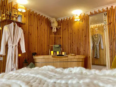a bedroom with a dressing room with a bed and a mirror at Gîte Les logis du Pech in Narbonne