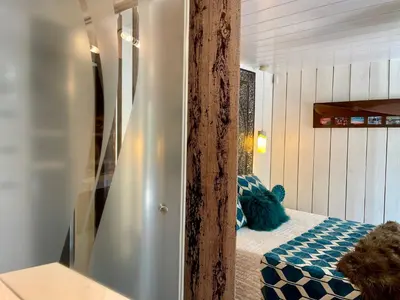a bedroom with a blue teddy bear sitting on a bed at Gîte Les logis du Pech in Narbonne