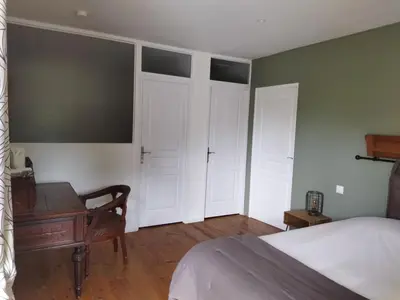 a bedroom with a bed and a desk next to a bed at Aur Blan - Les Pipistrelles in Le Somail