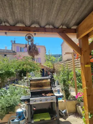 an outdoor grill in the middle of a garden at Le lorrain in Campagne-sur-Aude