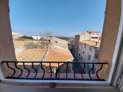 a view of a city from a balcony at centre historique et proche mer in Sigean