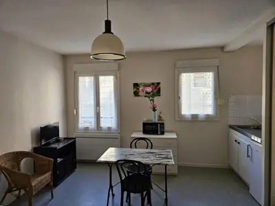 a kitchen with a table and chairs in a room at Résidence Anclo in Rennes-les-Bains