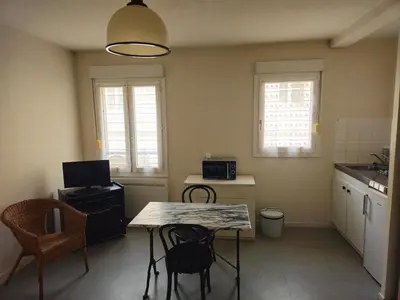 a small kitchen with a table and chairs in it at Résidence Anclo in Rennes-les-Bains