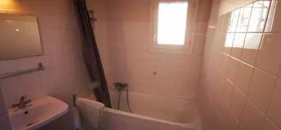a bathroom with a tub and a sink and a shower at Résidence Anclo in Rennes-les-Bains