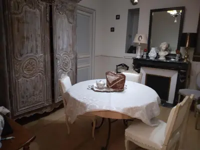 a dining room with a table and a fireplace at Beausejour in Lézignan-Corbières